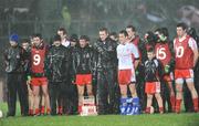 7 March 2009; The Tyrone squad stand for the national anthem, during a torrential downpour. Allianz GAA National Football League, Division 1, Round 3, Tyrone v Galway, Healy Park, Omagh, Co. Tyrone. Picture credit: Oliver McVeigh / SPORTSFILE