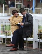 10 March 2009; Punters examine their race cards ahead of the opening day of the Cheltenham Racing Festival 2009. Cheltenham Racing Festival - Tuesday, Prestbury Park, Cheltenham, Gloucestershire, England. Picture credit: Stephen McCarthy / SPORTSFILE