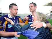 17 March 2009; Daisy Magee congratulates her sons Johnny and Darren after Kilmacud Crokes won the AIB All-Ireland Senior Club Football Championship Final match between Crossmaglen Rangers, Armagh and Kilmacud Crokes, Dublin at Croke Park in Dublin. Photo by Ray McManus/Sportsfile