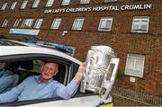 7 September 2015; Kilkenny manager Brian Cody holding the Liam MacCarthy Cup leaves Our Lady's Children's Hospital, Crumlin, in a Garda car following a visit by him and members of the victorious GAA Hurling All-Ireland Champions Kilkenny. Our Lady's Children's Hospital, Crumlin, Dublin. Picture credit: Stephen McCarthy / SPORTSFILE