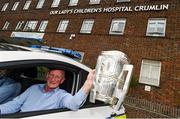 7 September 2015; Kilkenny's manager Brian Cody holding the Liam MacCarthy Cup leaves Our Lady's Children's Hospital, Crumlin, in a Garda car following a visit by him and members of the victorious GAA Hurling All-Ireland Champions Kilkenny. Our Lady's Children's Hospital, Crumlin, Dublin. Picture credit: Stephen McCarthy / SPORTSFILE