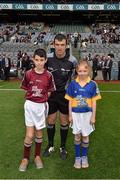 6 September 2015; Mark Kearns, Scoil Naomh Bhríde, Moycullen, Co. Galway, and Ellen Quigley, Kildangan N.S., Co. Tipperary, brought out the match sliotar to referee Paud O'Dywer, before the game. Electric Ireland GAA Hurling All-Ireland Minor Championship Final, Galway v Tipperary, Croke Park, Dublin. Picture credit: Ray McManus / SPORTSFILE