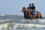 10 September 2015; Jockeys and horses ride through the surf before the races begin. Laytown Races, Laytown, Co. Meath. Picture credit: Cody Glenn / SPORTSFILE
