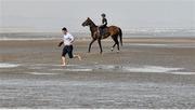 10 September 2015; Trainer Michael O'Callaghan runs ahead of his horse Mr. Bounty, ridden by 16 year old Sean Davis. Laytown Races, Laytown, Co. Meath. Picture credit: Cody Glenn / SPORTSFILE