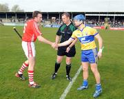 22 March 2009; Cork captain John Gardiner shakes hands with Clare captain Gerry O'Grady in front of referee Alan Kelly. Allianz GAA National Hurling League, Division 1, Round 4, Cork v Wexford, Cusack Park, Ennis, Co. Clare. Picture credit: Pat Murphy / SPORTSFILE