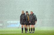 7 March 2009; Match officals, from left to right, Seamus McGonigle, linesman, Maurice Deegan, referee, and Barry Toland, linesman, withstand a torrential down pour during the National Anthem. Allianz GAA National Football League, Division 1, Round 3, Tyrone v Galway, Healy Park, Omagh, Co. Tyrone. Picture credit: Oliver McVeigh / SPORTSFILE