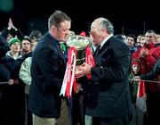 3 November 2000; Munster captain Mick Galwey, left, is presented with the Guinness Interprovincial Trophy, by Eddie Coleman, President of the IRFU following the Guinness Interprovincial Championship match between Leinster and Munster at Donnybrook in Dublin. Photo by Brendan Moran/Sportsfile