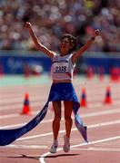 25 September 2000; Naoko Takahasi of Japan crosses the line to win the gold in the womens marathon during the Sydney Olympics at Sydney Olympic Park in Sydney, Australia. Photo by Brendan Moran/Sportsfile