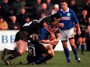 2 December 2000; Denis Hickie of St Mary's is tackled by Kieran Gallagher, Mike Mullins, 13, and Mike Fitzgerald of Young Munster. during the AIB League Division 1 match betweem St Mary's College and Young Munster at Templeville Road in Dublin. Photo by Brendan Moran/Sportsfile