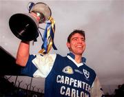 3 December 2000; Niall English of O'Hanrahans lifts the Sean McCabe Cup after AIB Leinster Club Football Championship Final match between O'Hanrahans and Na Fianna at O'Moore Park in Portlaoise. Photo by; David Maher/Sportsfile