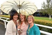 13 September 2015; Deirdre Regan, from left, her sister Michelle Regan and mother Josie Regan from Kilcormac, Co. Offaly arrive sharing an umbrella. Irish Champions Weekend. The Curragh, Co. Kildare. Picture credit: Cody Glenn / SPORTSFILE