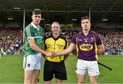 12 September 2015; Limerick captain Diarmaid Byrnes and Wexford captain Eoin Conroy exchange a handshake in the company of referee Johnny Ryan before the game. Bord Gais Energy GAA Hurling All-Ireland U21 Championship Final, Limerick v Wexford, Semple Stadium, Thurles, Co. Tipperary. Picture credit: Diarmuid Greene / SPORTSFILE