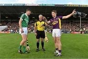 12 September 2015; Limerick captain Diarmaid Byrnes and Wexford captain Eoin Conroy with referee Johnny Ryan before the game. Bord Gais Energy GAA Hurling All-Ireland U21 Championship Final, Limerick v Wexford, Semple Stadium, Thurles, Co. Tipperary. Picture credit: Diarmuid Greene / SPORTSFILE