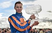 13 September 2015; Jockey Joseph O'Brien lifts the trophy after riding Order Of St. George to victory in the Palmerstown House Estate Irish St. Leger. Irish Champions Weekend. The Curragh, Co. Kildare. Picture credit: Cody Glenn / SPORTSFILE