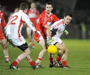 28 March 2009; Martin Penrose, Tyrone, in action against Gerard O'Kane, Derry. Allianz GAA NFL Division 1 Round 6, Healy Park, Omagh, Co. Tyrone. Picture credit: Oliver McVeigh / SPORTSFILE