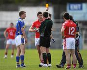 28 March 2009; Brian Jones, left, Tipperary, and Chris O'Donovan, Cork, are shown a second yellow card each by referee Aidan Mangan. This was O'Donovan's second and was sent off. Cadbury Munster U21 Football Championship Final, Tipperary v Cork, Semple Stadium, Thurles, Co. Tipperary. Picture credit: Ray McManus / SPORTSFILE
