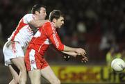28 March 2009; Enda Muldoon, Derry, in action against Ryan Mellon, Tyrone. Allianz GAA NFL Division 1 Round 6, Healy Park, Omagh, Co. Tyrone. Picture credit: Oliver McVeigh / SPORTSFILE