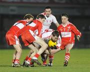28 March 2009; Brian McGuigan, Tyrone, in action against Sean Leo McGoldrick, Enda Muldoon and Paul Cartin, Derry. Allianz GAA NFL Division 1 Round 6, Healy Park, Omagh, Co. Tyrone. Picture credit: Oliver McVeigh / SPORTSFILE
