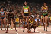 30 August 2015; Gold medalists, from left, Shericka Jackson of Jamaica, Stephenie Ann McPherson of Jamaica, Novlene Williams-Mills of Jamaica and Christine Day of Jamaica look to the scoreboard following the Women's 4x400m Relay Final. IAAF World Athletics Championships Beijing 2015 - Day 9, National Stadium, Beijing, China. Picture credit: Stephen McCarthy / SPORTSFILE