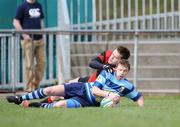 5 April 2009; Navan RFC's Simon Hogan goes over to score his side's first try despite the attentions of Tullamore's Colin Hughes. AIB Junior Cup Final, Tullamore v Navan RFC, Dubarry Park, Athlone, Co. Westmeath. Picture credit: Brian Lawless / SPORTSFILE