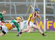 5 April 2009; Wexford's Diarmuid Lyng scores the third goal of the game despite the attempts of Offaly's Ger Oakley, 6, and goalkeeper Brian Mullins. Allianz GAA NHL Division 2 Round 6, Wexford v Offaly, Wexford Park, Wexford. Picture credit: Matt Browne / SPORTSFILE