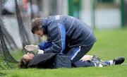5 April 2009; Waterford team doctor Dr. Tom Higgins puts stitches in an eye injury of Richie Foley. Allianz GAA NHL Division 1 Round 6, Limerick v Waterford, Gaelic Grounds, Limerick. Picture credit: Brendan Moran / SPORTSFILE *** Local Caption ***