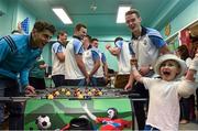 21 September 2015; Dublin's Bernard Brogan and Brian Fenton enjoy a game of Fussball with Dylan Muprhy, age 6, from Clondalkin, Co. Dublin, during a visit from the GAA Football All-Ireland Champions Dublin to Our Lady's Children's Hospital, Crumlin, Dublin. Picture credit: David Maher / SPORTSFILE