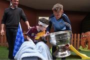 21 September 2015; Dublin's Jonny Cooper with 6 year Dean Fallon and his father Joe, from Ballinasloe, Co. Galway, during a visit from the GAA Football All-Ireland Champions Dublin to Our Lady's Children's Hospital, Crumlin, Dublin. Picture credit: David Maher / SPORTSFILE