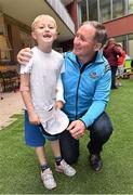 21 September 2015; Dublin manager Jim Gavin with 6 year Dylan Murphy, from Clondalkin, Co. Dublin, during a visit from the GAA Football All-Ireland Champions Dublin to Our Lady's Children's Hospital, Crumlin, Dublin. Picture credit: David Maher / SPORTSFILE