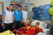 21 September 2015; Dublin's Philly McMahon, left, Bernard Brogan, centre, and Denis Bastick meet 5 year-old Donegal supporter Declan Meehan, from Letterkenny, during a visit from the GAA Football All-Ireland Champions Dublin to Temple Street Children’s Hospital. Temple Street, Dublin. Picture credit: Ramsey Cardy / SPORTSFILE
