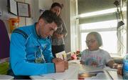 21 September 2015; Dublin's Bernard Brogan signs an autograph for 9 year old Cesara Maria Focsa, from Kilkenny, during a visit from the GAA Football All-Ireland Champions Dublin to Temple Street Children’s Hospital. Temple Street, Dublin. Picture credit: Ramsey Cardy / SPORTSFILE