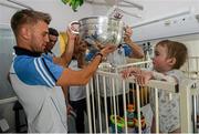 21 September 2015; Dublin's Jonny Cooper hands 20 month old Matthew Carroll-Kiely, from Mitchelstown, Co. Cork, the Sam Maguire cup during a visit from the GAA Football All-Ireland Champions Dublin to Temple Street Children’s Hospital. Temple Street, Dublin. Picture credit: Ramsey Cardy / SPORTSFILE