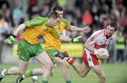 12 April 2009; Gerard O'Kane, Derry, in action against Brendan Boyle and Michael Doherty, Donegal. Allianz GAA National Football League, Division 1, Round 7, Derry v Donegal, Maghera, Co. Derry. Picture credit: Oliver McVeigh / SPORTSFILE *** Local Caption ***