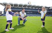 21 April 2009; Dublin senior footballer Ross McConnell watches as Eimear Cahill, left, from Laragh, Co. Cavan, and Ally Cahill, from Killygarry, Co. Cavan, practice their handpassing skills during the Launch of the 2009 VHI GAA Cúl Camps. Now in its fourth year, the VHIGAA Cul Camps is a nationally co-ordinated programme which aims to encourage primary school children between the ages of 7 and 13, to learn and develop sporting and life-skills by participating in Gaelic games, in a fun, non-competitive environment. Last year over 83,000 children attended the VHI GAA Cúl Camps nationwide. Croke Park, Dublin. Picture credit: Diarmuid Greene / SPORTSFILE