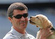 30 April 2009; Recently appointed Ipswich Town manager and Irish soccer legend Roy Keane with puppy in training Ella at the official launch of the seventh annual Irish Guide Dogs for the Blind Specsavers Shades 2009 campaign. The campaign raises funds for the training of guide and assistant dogs and centres around a week of fundraising nationwide which kicks off on Monday 4th May 2009. Croke Park, Dublin. Picture credit: Brendan Moran / SPORTSFILE