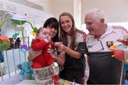 28 September 2015; 28 week old Josh O'Callaghan, from Watergrasshill, Co. Cork, and his mother Mags with Cork ladies footballer Kate Leneghan and team manager Eamonn Ryan during a visit by the TG4 Ladies Football All-Ireland Senior Champions to  Crumlin Children's Hospital, Crumlin, Dublin. Picture credit: Matt Browne / SPORTSFILE