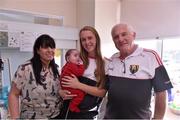 28 September 2015; 28 week old Josh O'Callaghan, from Watergrasshill, Co. Cork, and his mother Mags with Cork ladies footballer Kate Leneghan and team manager Eamonn Ryan during a visit by the TG4 Ladies Football All-Ireland Senior Champions to  Crumlin Children's Hospital, Crumlin, Dublin. Picture credit: Matt Browne / SPORTSFILE