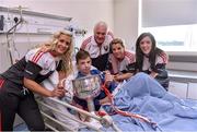 28 September 2015; 12 year old Kieran McCarthy, from Watergrasshill, Co. Cork, with Cork ladies footballers Brid Stack, team manager Eamonn Ryan, Valerie Mulcahy and team captain Ciara O'Sullivan during a visit by the TG4 Ladies Football All-Ireland Senior Champions to  Crumlin Children's Hospital, Crumlin, Dublin. Picture credit: Matt Browne / SPORTSFILE