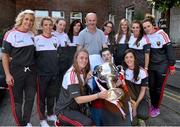 28 September 2015; James Walsh, from Moycullen, Co. Galway, and his dad Martin with members of the Cork ladies football team during a visit by the TG4 Ladies Football All-Ireland Senior Champions to  Crumlin Children's Hospital, Crumlin, Dublin. Picture credit: Matt Browne / SPORTSFILE