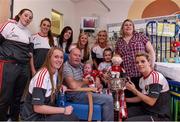 28 September 2015; 10 month old Daniel Sheehan, from Larchfiels, Cork City, with his grandad Ger O'Callaghan, sister 6 year old Sarah, mother Michelle and Cork ladies footballers from left Laura Crowley, Aisling Hutchings, Kate Leneghan, Aisling Barrett, Roisin Phelan, Brid Stack and Valerie Mulcahy during a visit by the TG4 Ladies Football All-Ireland Senior Champions to  Crumlin Children's Hospital, Crumlin, Dublin. Picture credit: Matt Browne / SPORTSFILE