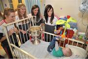 28 September 2015; Joshua McDonald, 9 months old, from Limerick City, Co. Limerick, with Cork ladies footballers, from left, Aisling Hutchings, Rois’n Phelan, Ciara O'Sullivan and Aisling Barrett during a visit by the TG4 Ladies Football All-Ireland Senior Champions to Temple Street Hospital, Temple Street, Dublin. Picture credit: Sam Barnes / SPORTSFILE