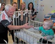 28 September 2015; Joshua McDonald, 9 months old, from Limerick City, Co. Limerick, with Cork ladies football manager Eamonn Ryan and players, from left, Aisling Hutchings, Rois’n Phelan and Ciara O'Sullivan during a visit by the TG4 Ladies Football All-Ireland Senior Champions to Temple Street Hospital, Temple Street, Dublin. Picture credit: Sam Barnes / SPORTSFILE