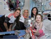 28 September 2015; Isabel O'Dwyer, from Dublin, with Cork ladies footballers, from left, Aisling Hutchings, Brid Stack and Ciara O'Sullivan during a visit by the TG4 Ladies Football All-Ireland Senior Champions to Temple Street Hospital, Temple Street, Dublin. Picture credit: Sam Barnes / SPORTSFILE