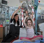 28 September 2015; Isabel O'Dwyer, from Dublin, with Cork ladies footballer Ciara O'Sullivan during a visit by the TG4 Ladies Football All-Ireland Senior Champions to Temple Street Hospital, Temple Street, Dublin. Picture credit: Sam Barnes / SPORTSFILE