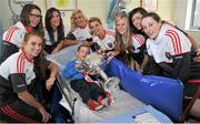 28 September 2015; Eoin O'Brien, age 6, from Shannon, Co. Clare, with Cork ladies footballer's, from left, Aisling Hutchings, Sinead Cotter, Ciara O'Sullivan, Brid Stack, Valerie Mulcahy, Roisin Phelan, Aisling Barret and Aine Terry during a visit by the TG4 Ladies Football All-Ireland Senior Champions to Temple Street Hospital, Temple Street, Dublin. Picture credit: Sam Barnes / SPORTSFILE