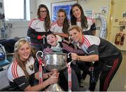 28 September 2015; Eoin Ward, age 12, from Clonard, Co. Meath, with Cork ladies footballers, from left, Roisin Phelan, Sinead Cotter, Aisling Hutchings, Ciara O'Sullivan and Valerie Mulcahy during a visit by the TG4 Ladies Football All-Ireland Senior Champions to Temple Street Hospital, Temple Street, Dublin. Picture credit: Sam Barnes / SPORTSFILE