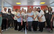 28 September 2015; Members of staff on The Day Ward pose for a photo with the Eamonn Ryan and members of the Cork team during a visit by the TG4 Ladies Football All-Ireland Senior Champions to Temple Street Hospital, Temple Street, Dublin. Picture credit: Sam Barnes / SPORTSFILE