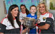 28 September 2015; Mason Mulligan, age 3, from Pearse Street, Co. Dublin, with Cork ladies footballers, from left, Ciara O'Sullivan, Aisling Hutchings and Brid Stack during a visit by the TG4 Ladies Football All-Ireland Senior Champions to Temple Street Hospital, Temple Street, Dublin. Picture credit: Sam Barnes / SPORTSFILE