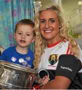 28 September 2015; Mason Mulligan, age 3, from Pearse Street, Co. Dublin, with Cork ladies footballer Brid Stack during a visit by the TG4 Ladies Football All-Ireland Senior Champions to Temple Street Hospital, Temple Street, Dublin. Picture credit: Sam Barnes / SPORTSFILE