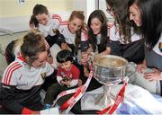 28 September 2015; Fareed Nahari, Age 2, from Clonsilla, Co. Dublin, with Cork ladies footballers, from left, Aine Terry, Aisling Hutchings, Ciara O'Sullivan, Sinead Cotter and Aisling Barrett during a visit by the TG4 Ladies Football All-Ireland Senior Champions to Temple Street Hospital, Temple Street, Dublin. Picture credit: Sam Barnes / SPORTSFILE